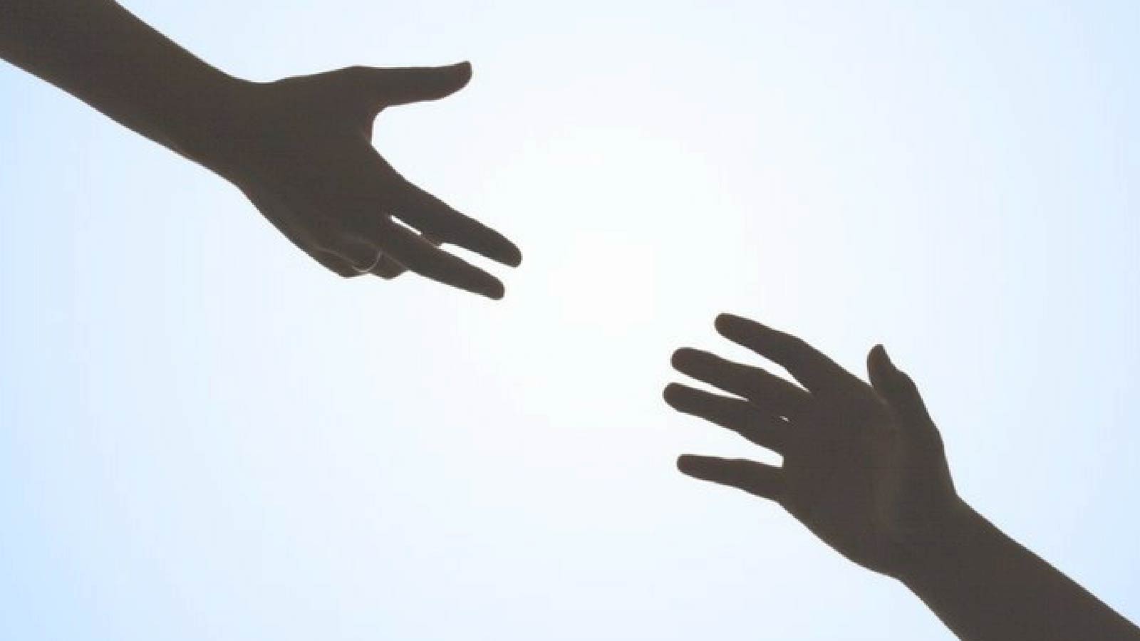 Two hands reaching toward each other