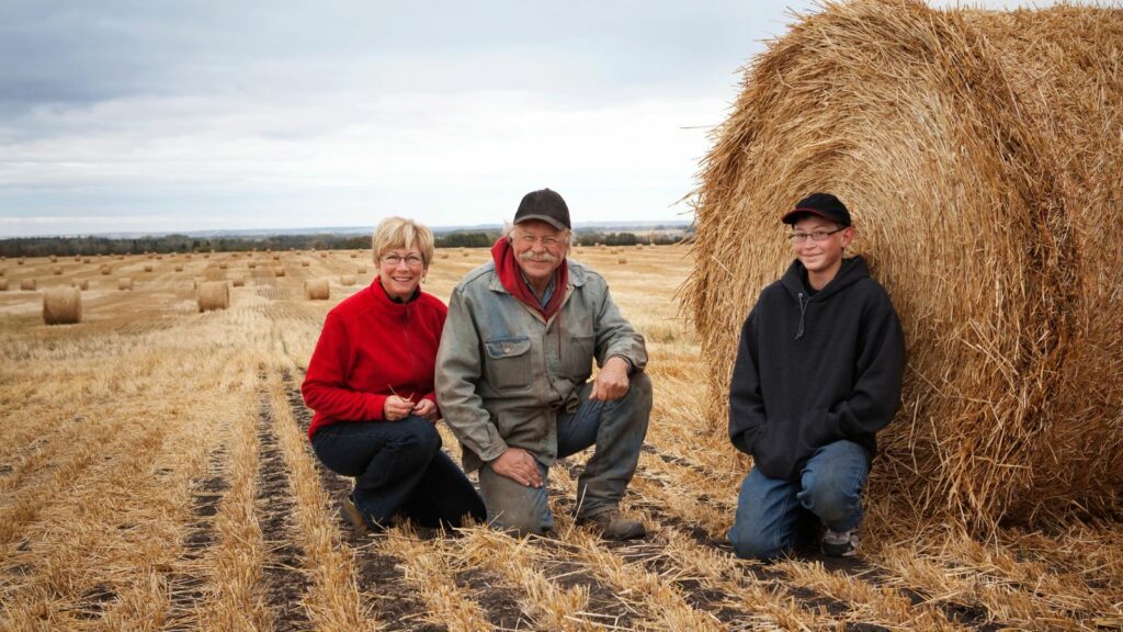 A family on a farm hay field