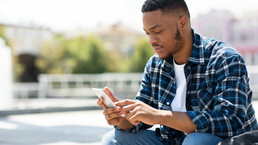 man looking at app on phone