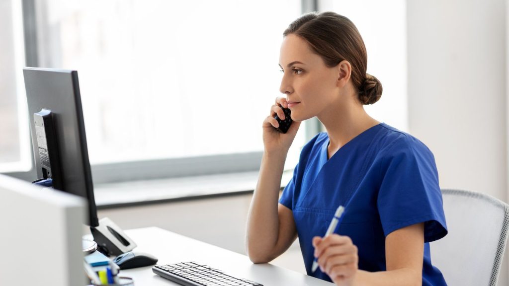 Healthcare provider using the computer and on the phone