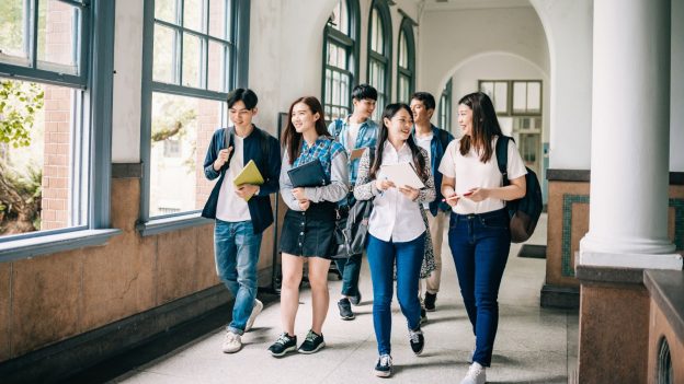 students walking down a school hallway